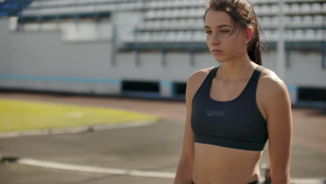 Slow-motion:-Girl-athlete-waits-for-start-of-race-in-400-meters.-girl-athlete-waits-for-start-of-race-in-100-meters-during.-Running-at-the-stadium-from-the-pads-on-the-treadmill